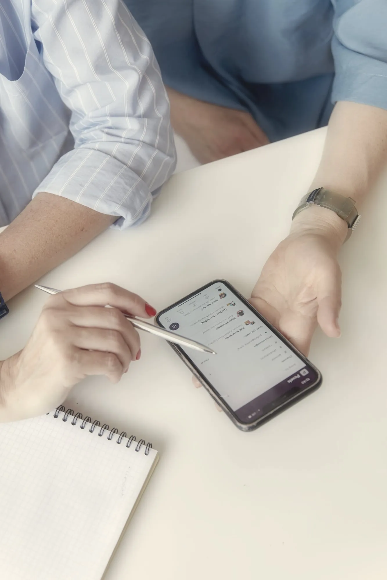 An adviser at a desk with a laptop and notes during a phone call